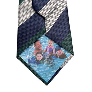 green and navy tie with picture of man and children swimming